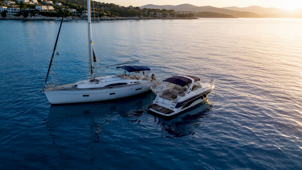 Sailing yacht and motorboat anchored in Greek waters