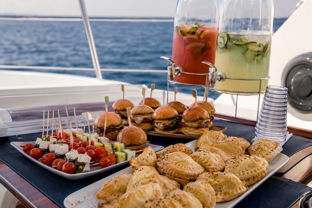 Finger foods and bottled cocktails on sailboat table