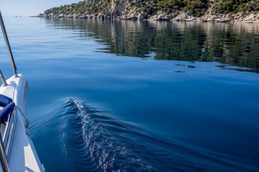 Cropped sailing boat bow on calm sea