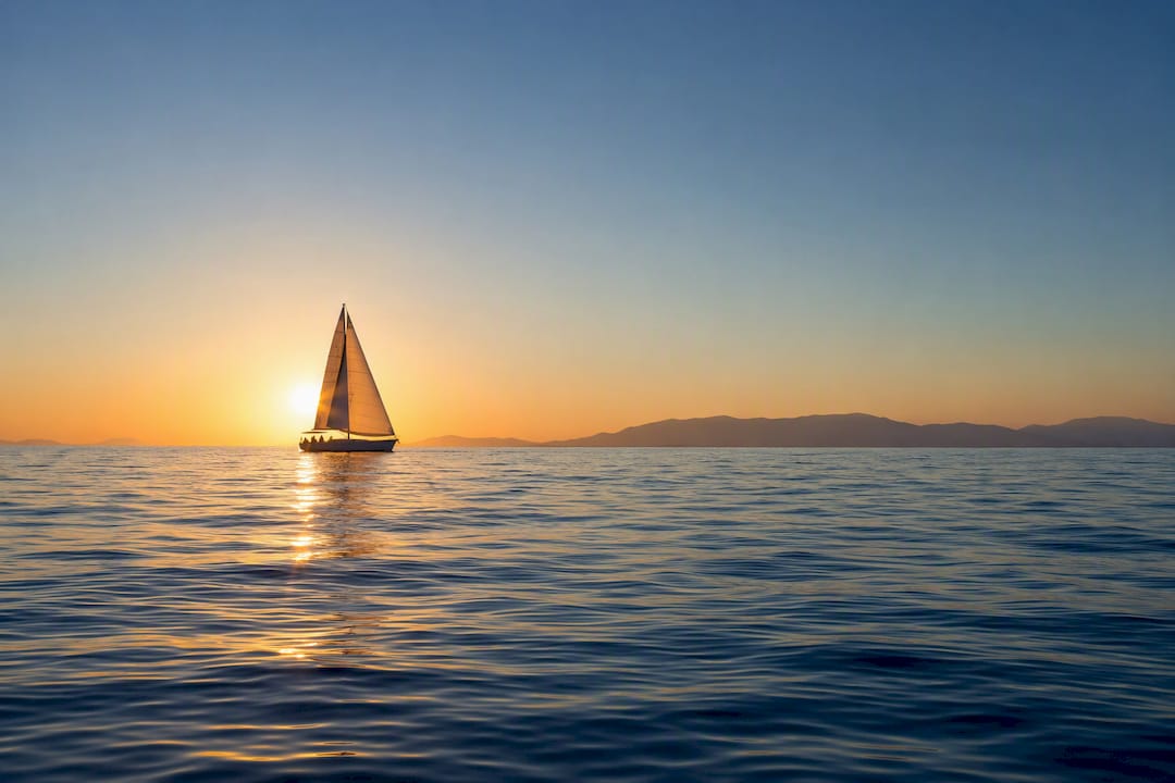 Sailing boat on calm Halkidiki water at dawn