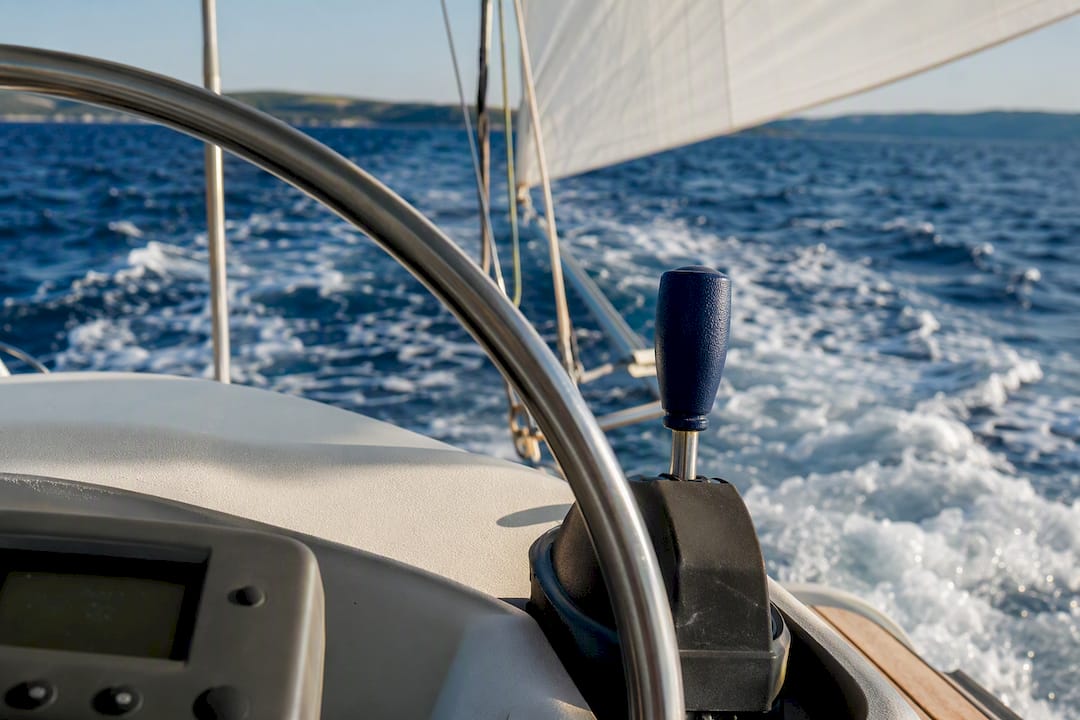 Cropped sailing boat controls above open sea