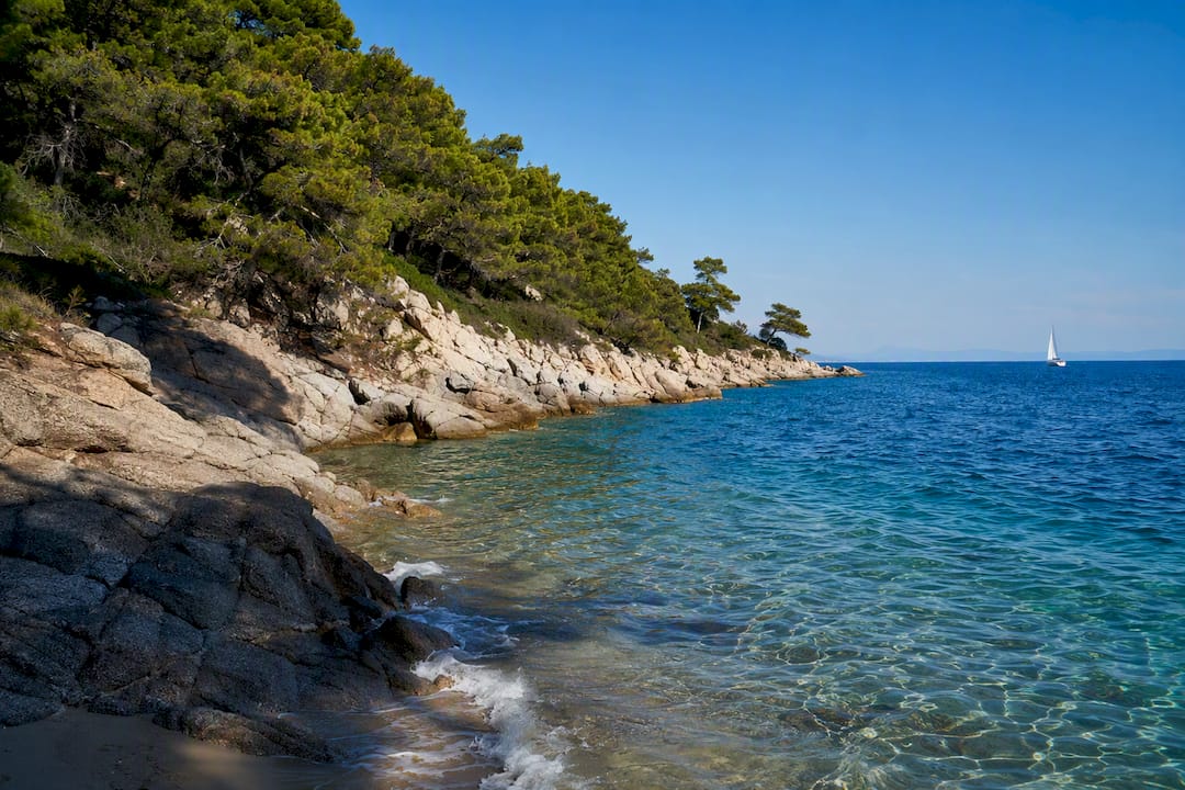 Quiet Sithonia coast with sailing boat