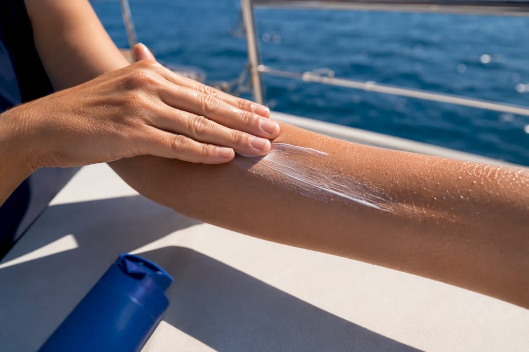 Hand applying sunscreen in even strokes