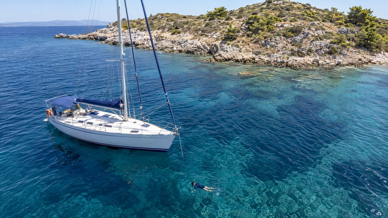 Sailing boat and snorkeler off Kelyfos Sailing boat and snorkeler off Kelyfos