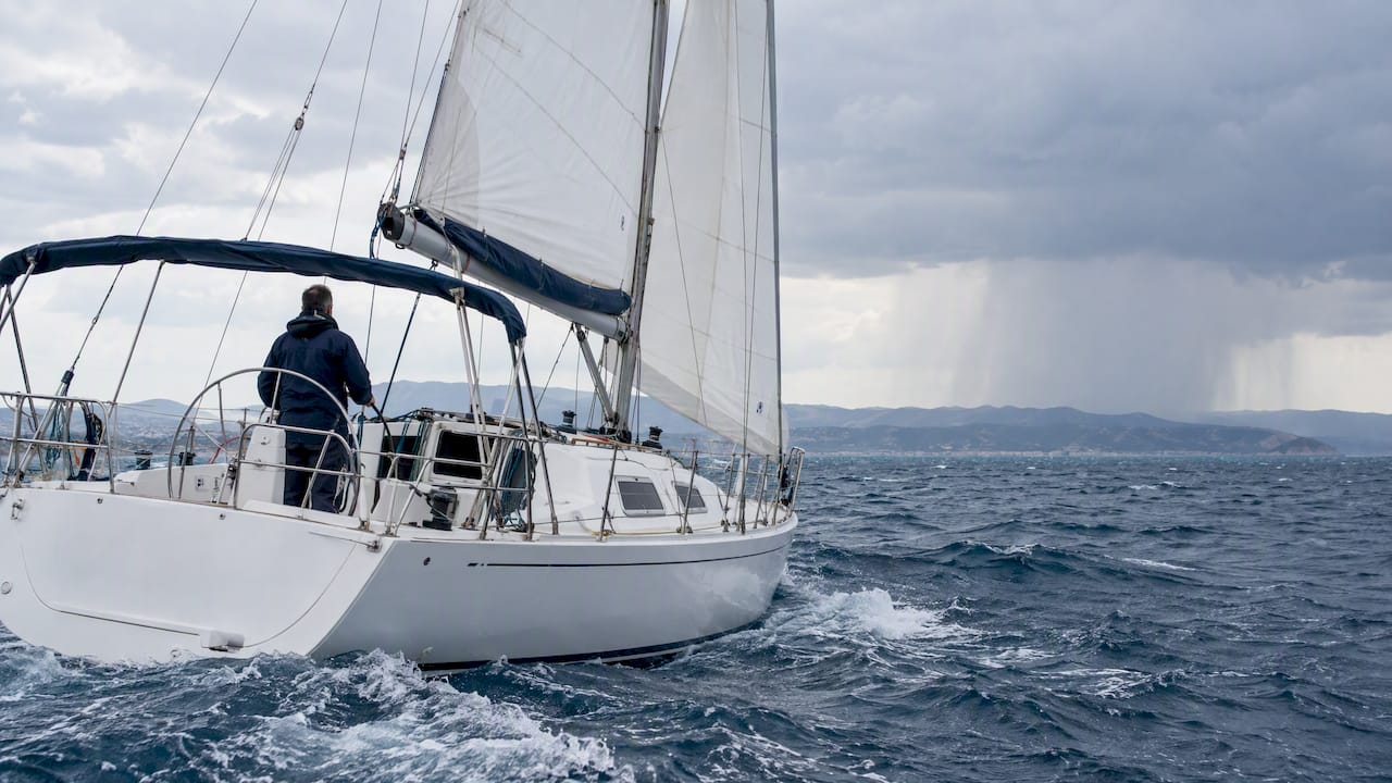 Sailing boat under wind-driven rain in Halkidiki